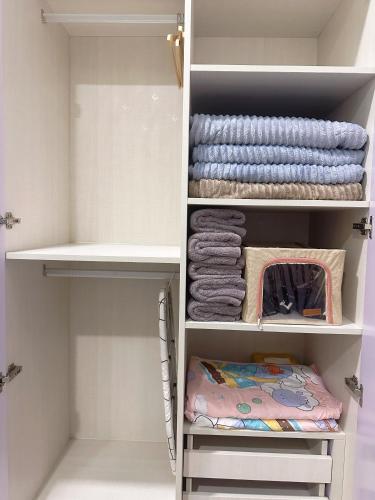 a walk in closet with towels and towels at Opposite Legoland 5mins Medini DPristine 8 to 10pax in Nusajaya