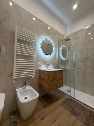 a bathroom with a sink and a toilet and a shower at CIAO PARTENOPE - luxury rooms in Naples
