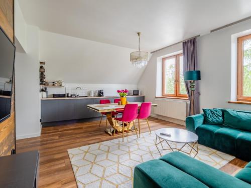 a living room with a couch and a table at Villa Jarosta Premium & SPA in Zakopane
