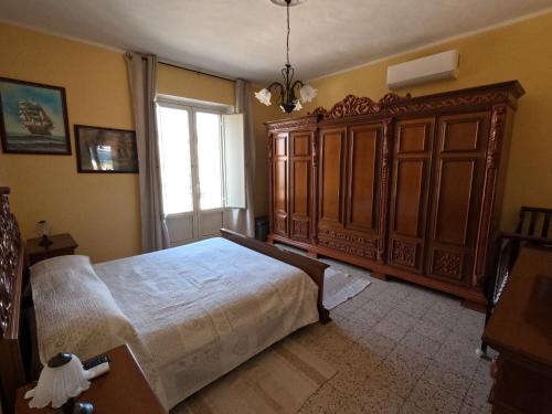 a bedroom with a large bed and a window at Dimora Sardo in Pietramelara