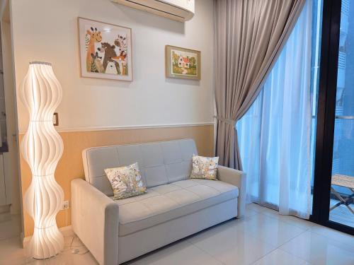 a living room with a couch and a floor lamp at Opposite Legoland 5mins Medini DPristine 8 to 10pax in Nusajaya