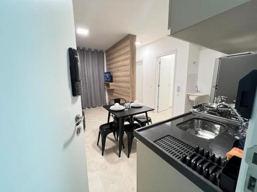 a small kitchen with a table and a counter top at LK Centro 10 in Belo Horizonte