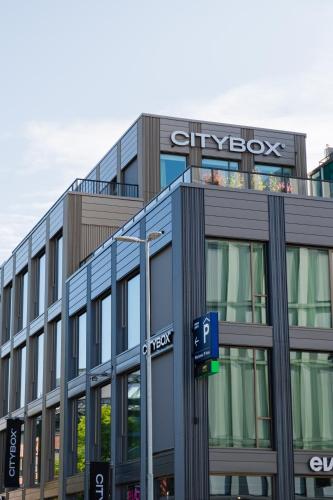 a building with a sign on the top of it at Citybox Kristiansand in Kristiansand