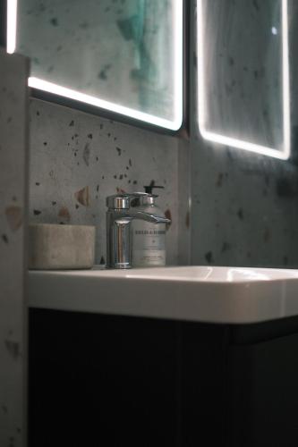 a bathroom sink with a bottle on top of it at Luxury Private Room in Central Oxford - Great Location in Oxford