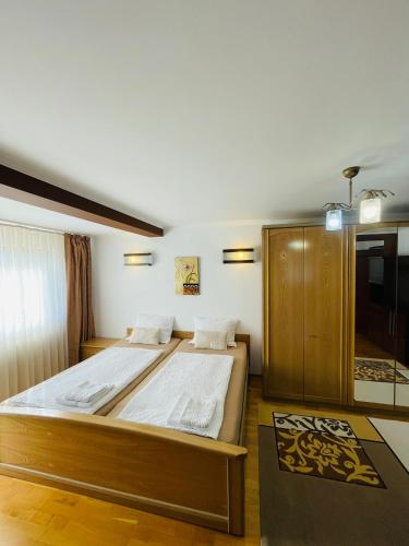 a bedroom with a large bed in a room at Vila Madisa in Buşteni