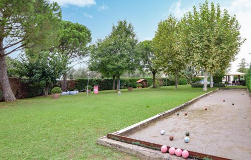 a large yard with a sandbox with balls in it at Cozy Apartment In Castiglione Del Lago in Castiglione del Lago