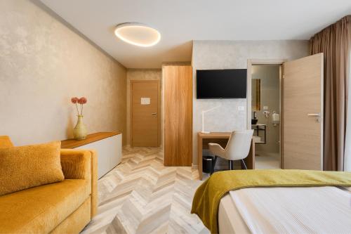 a hotel room with a bed and a desk at Pula City Center Accommodation - Breakfast included in Pula