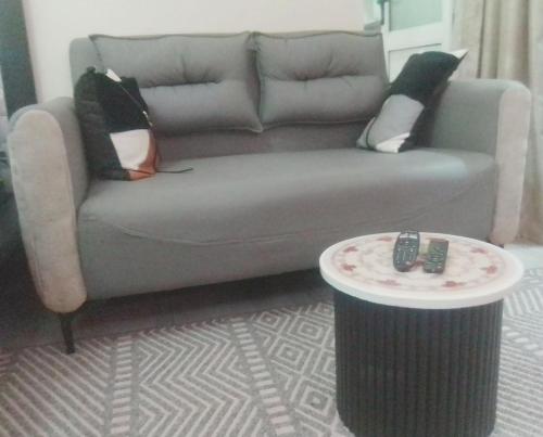 a living room with a couch and a table at Sambras in Kampala