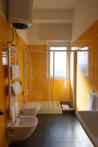 a bathroom with two sinks and a shower and two toilets at Hotel Riva Del Sole in Giovinazzo