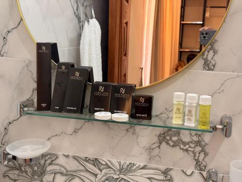 a shelf with cosmetics on it in a bathroom at Nestopia Islamabad in Islamabad