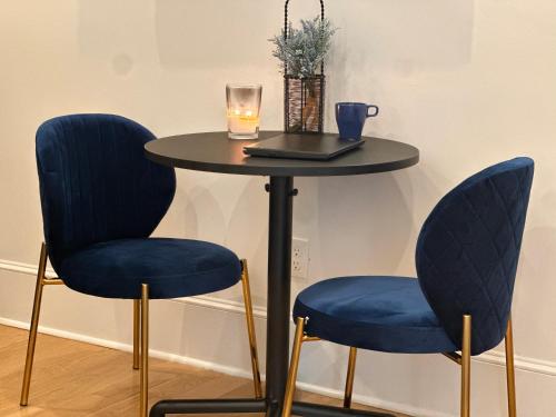 two blue chairs and a table with a laptop on it at Cozy 1BR Apt Downtown Steps from Convention Center in Providence