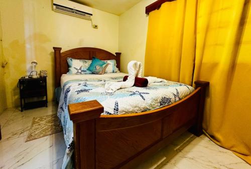 a bedroom with a bed with a stuffed animal on it at Seaview Escape Tobago in Lambeau