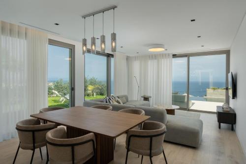 a living room with a table and chairs and a couch at Villa Guindaste I by An Island Apart in Santana