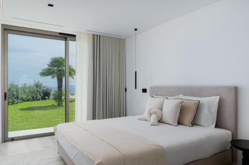 a bedroom with a large bed with a large window at Villa Guindaste I by An Island Apart in Santana