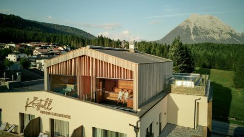 a house with a view of a mountain at Hotel Kristall - Adults only in Leutasch