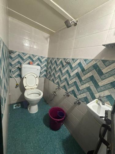 a bathroom with a toilet and a sink at Kapoor dormitory in Mumbai