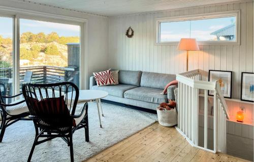 a living room with a couch and a table at Cozy Home In Bjönni With Sauna in Ellös
