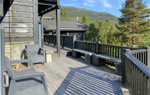 a wooden deck with two benches and a building at Pet Friendly Home In Bjorli With Sauna in Bjorli