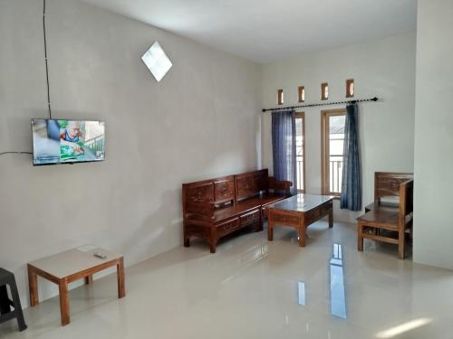 a living room with a couch and a table at Bromo Jay House Homestay IV in Sukapura