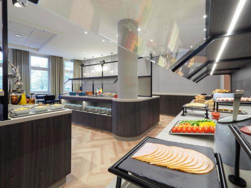 a kitchen with a bunch of food on display at ibis Styles Bielefeld City in Bielefeld