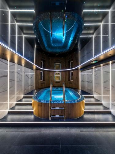 a large plunge pool in a room with stairs at H Aparthotel in Ełk