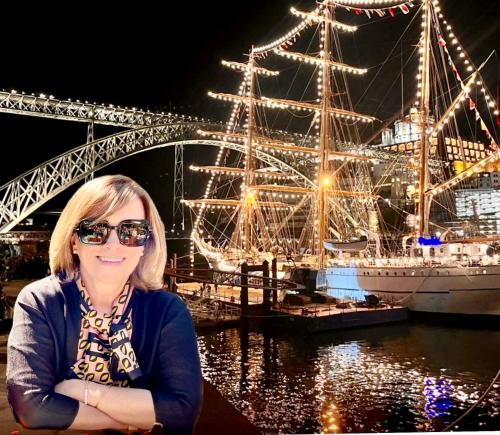 a woman is standing in front of a large ship at Urban Apartment Casa da Portela in Porto