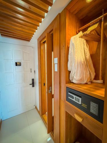 a small room with a closet with a door at Aqua Horizon Beachside Condo I Signature Art Suites in Dauis