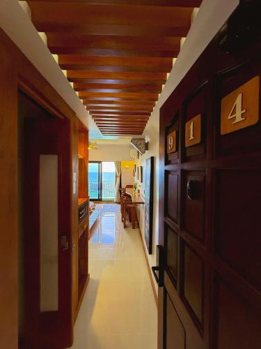 a room with a hallway with a wooden ceiling at Aqua Horizon Beachside Condo I Signature Art Suites in Dauis