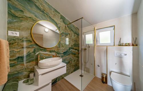 a bathroom with a sink and a mirror at Apartment Karbuni Royal by Villas Guide in Brnistrova