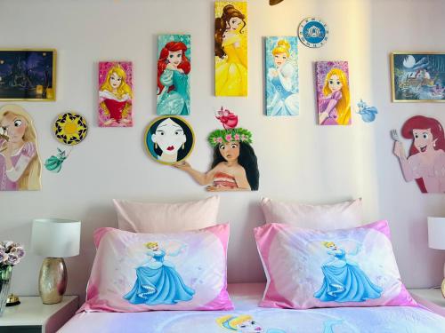a bedroom with disney princess pictures on the wall at THE ENCHANTED HOUSE ( 15 min walk to Disney) in Serris