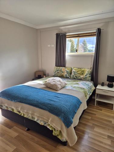 a bedroom with a large bed with a window at Guyra 1 Bedroom Apartment Country Retreat in Guyra
