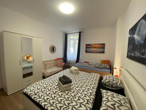 a bedroom with a bed and a crib in it at Art Design Gallery - Bratislava city center in Bratislava