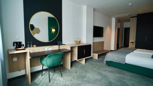 a hotel room with a bed and a sink and a mirror at Hotel Diplomat in Zagreb