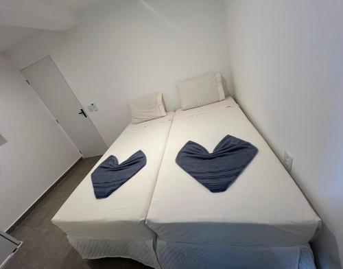 a bedroom with a bed with two blue hearts on it at Manaira Suite 03 in João Pessoa