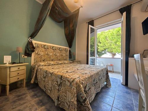 a bedroom with a bed and a window at Hotel Sant'Andrea in Marciana