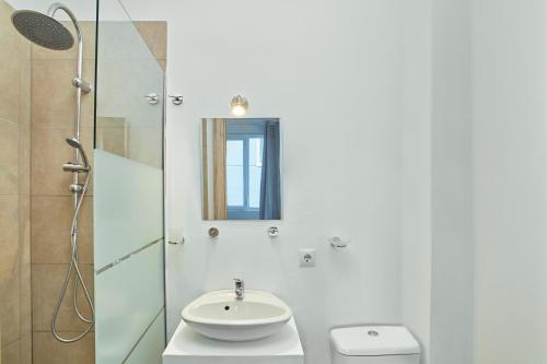 a white bathroom with a sink and a toilet at ATHENS COMMERCIAL in Athens