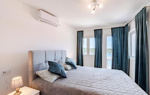 a bedroom with a large bed with blue curtains at Apartment President by Villas Guide in Brnistrova