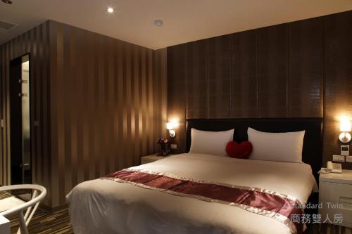 a bedroom with a bed with a red heart on it at Grace Hotel in Taipei