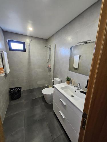 a bathroom with a white sink and a toilet at São Cristóvão AL in Boaventura