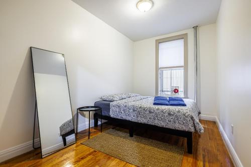 a bedroom with a bed and a mirror at Inspire the vibrant energy of Columbia University in New York