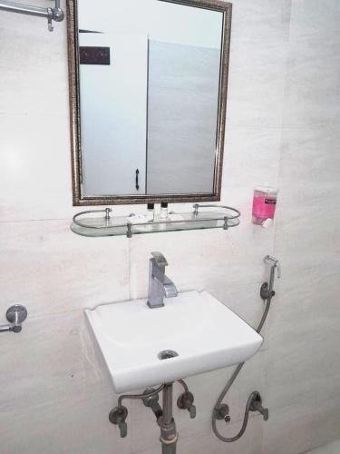 a bathroom with a sink and a mirror at Little Ganesha Inn in Jaipur