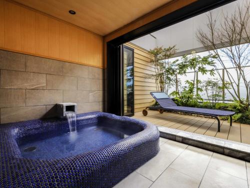 a large blue bath tub sitting on a patio at Mercure Hida Takayama in Takayama