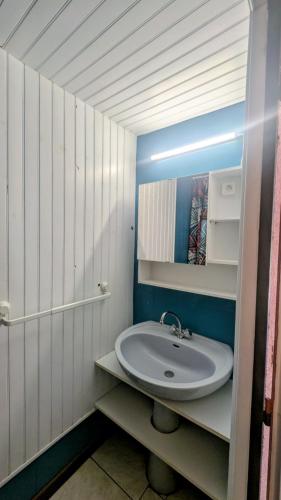 a white bathroom with a sink and a mirror at Gite la Capelle près de la réserve Africaine de Sigean et Narbonne à 10 min des plages in Roquefort-des-Corbières