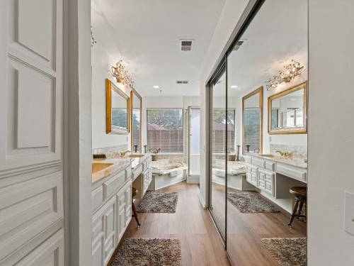 a bathroom with two sinks and two mirrors at North Dallas Retreat - 3 BR - Spacious Backyard in Addison