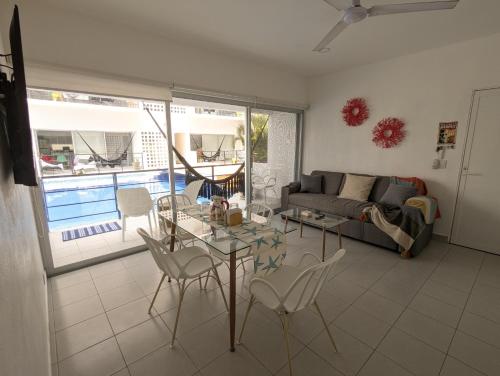a living room with a couch and a table and chairs at Adults Only Condo Close to the Beach in Acapulco