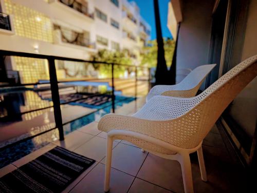 two chairs sitting on the balcony of a building at Adults Only Condo Close to the Beach in Acapulco