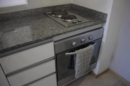 a kitchen with a stove with a towel on the oven at Urquiza Suite Premium Rental in Buenos Aires