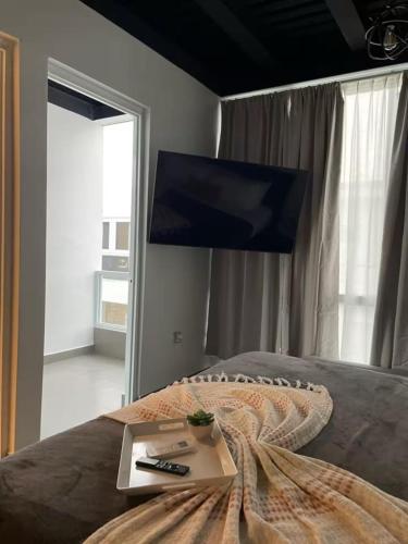 a bedroom with a bed with a laptop on it at Rosalina Ocean Park in San Juan