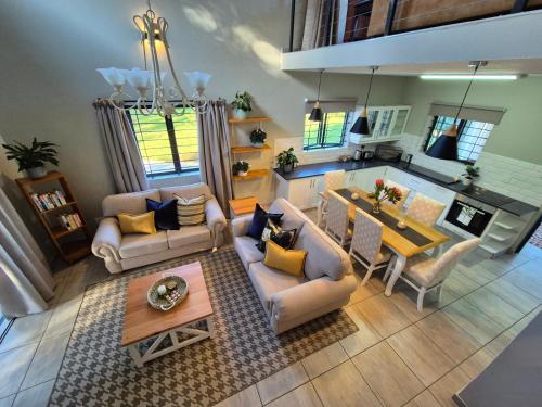 an overhead view of a living room and kitchen with a table at Courtleigh Cottage in Hilton
