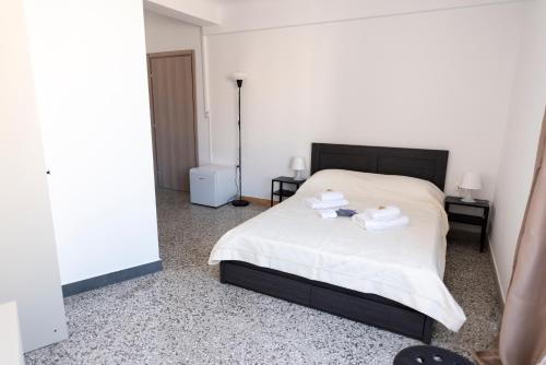 a bedroom with a bed with two towels on it at ATHENS COMMERCIAL in Athens